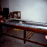 Core preparation at Woods Hole Oceanographic Institution (WHOI), Woods Hole, Mass. This machine was used to draw a knife blade through opposite sides of the plastic core liner before splitting.