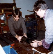Dr. Paul Gayes (right, Coastal Carolina College) and an unidentified technician use a wire to slice the cores lengthwise along the slits cut in the core liner. This process results in the core halves shown in a picture below.