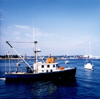 RV ASTERIAS (Woods Hole Oceanographic Institution, WHOI) in New London Harbor, CT, for Cruise 82-3.  Captain Arthur D. ("Dick") Colburn (WHOI) at the helm with Sally Needell (Chief Scientist) and Jack Connell (both with USGS) on deck.	