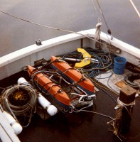 EG&G and ORE "boomer" seismic-profiling system sleds and hydrophones along with a Klein sidescan sonar fish (upper right, with yellow depressor wing attached) on the deck of the RV ASTERIAS during AST 85-8.