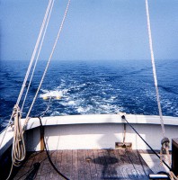 Picture looks directly aft on the RV ASTERIAS during cruise AST82-3.  An EG&G "Uniboom" sound-source sled is deployed to the left (starboard side), the accompanying Benthos hydrophone is streaming along the sea surface to the far right, and the sidescan sonar is deployed over the stern in the middle.