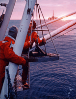 Photograph of Modified Van Veen (2) Grab Sampler being deployed at sea.