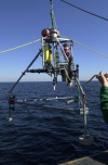 Image of instrumented tripod being deployed from USCG Cutter Marcus Hanna.