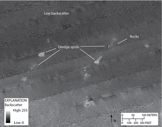 Figure 12. Detailed sidescan-sonar image showing dredge spoils in the southwestern part of the study area. An area of low backscatter can be seen in the northern part of the image. Boulders, characterized by high-backscatter targets with low-backscatter shadows, comprise some of the dredge spoils. Location of image shown in figure 2. 